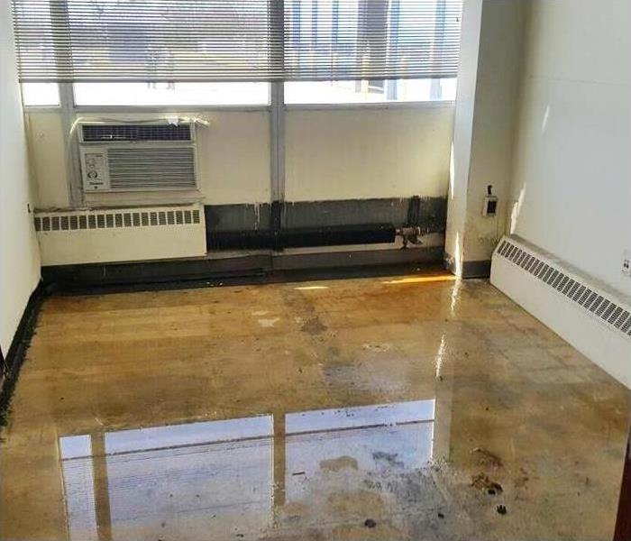 Office building with extensive flooding on floors and walls